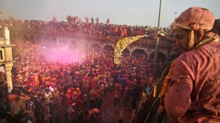 Villagers from Barsana and Nandgaon smeared with colors play Lathmar Holi at Nandagram temple in Nandgoan village, 115 kilometers (70 miles) south of New Delhi, India, Tuesday, March 19, 2024. Women from Nandgaon, the birthplace of Hindu God Krishna, beat the men from Barsana, the legendary birthplace of Radha, the consort of Krishna, with wooden sticks in response to their efforts to put color on them. The same act is then replicated in Barsana between the women of that village and the men of Nandgaon as they observe the Lathmar Holi festival, a celebration of love and friendship. (AP Photo/Kabir Jhangiani)