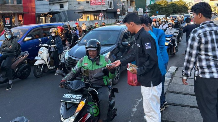 Mahasiwa yang tergabung dalam organisasi Dema PTKIN membagikan takjil di jalanan Tangsel, Selasa (19/3/2024).