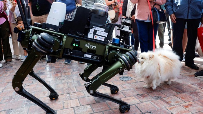 People watch a police robot dog aimed at helping enforce traffic laws for E-scooters, during its presentation to the media, in Malaga, southern Spain March 19, 2024. REUTERS/Jon Nazca