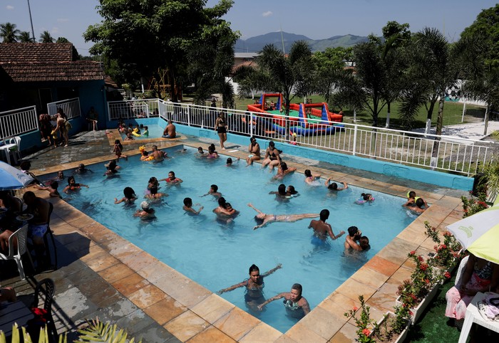 People refresh in a pool of a private club, in Guaratiba neighbourhood, amid a heatwave in Rio de Janeiro, Brazil, March 17, 2024. REUTERS/Ricardo Moraes