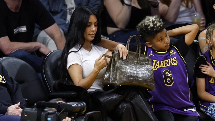LOS ANGELES, CALIFORNIA - MARCH 16:  Kim Kardashian and Saint West attend a basketball game between the Los Angeles Lakers and Golden State Warriors at Crypto.com Arena on March 16, 2024 in Los Angeles, California. NOTE TO USER: User expressly acknowledges and agrees that, by downloading and or using this photograph, User is consenting to the terms and conditions of the Getty Images License Agreement. (Photo by Kevork Djansezian/Getty Images)