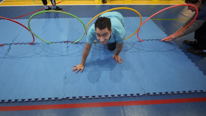 A woman with Down Syndrome takes part in a sports demonstration marking the upcoming World Down Syndrome Day, in Bucharest, Romania, Tuesday, March 19, 2024. (AP Photo/Andreea Alexandru)