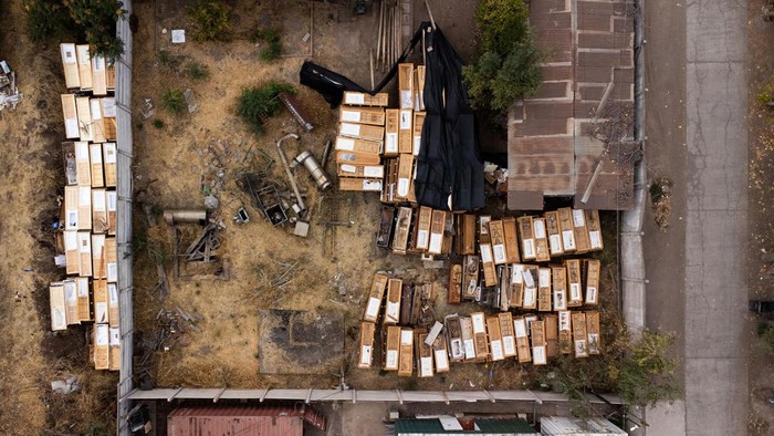 A drone view shows remains of used caskets among garbage at Santiago's General Cemetery, Chile, March 20, 2024. REUTERS/Ivan Alvarado