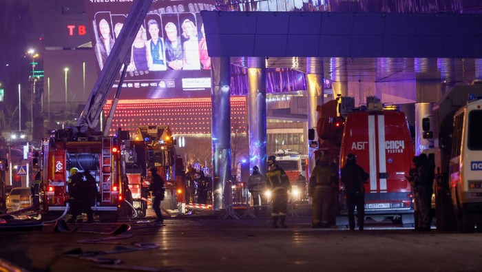 Vehicles of Russian emergency services are parked near the burning Crocus City Hall concert venue following a reported shooting incident, outside Moscow, Russia, March 22, 2024. REUTERS/Maxim Shemetov     TPX IMAGES OF THE DAY