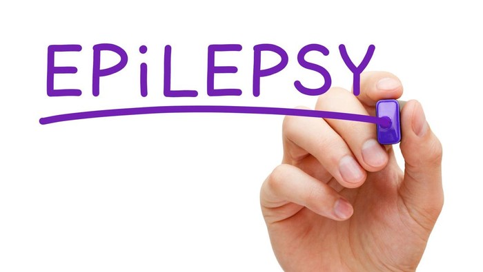 A child being cared for during an epileptic seizure by a qualified special needs carer