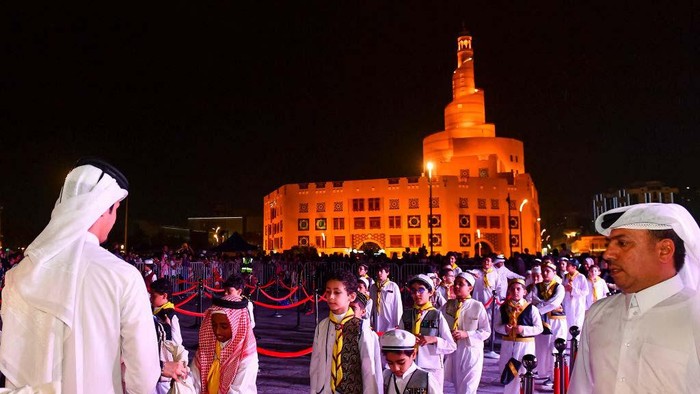 A man is distributing bags of sweets and candy to children at a Garangao celebration at Souq Waqif Traditional Market in Doha, Qatar, on March 24, 2024. The festival, which is primarily celebrated in the Gulf countries, features sweets, nuts, gifts, and games as staples of the age-old Gulf tradition known as Garangao, and it is being celebrated after the sunset prayer on the 14th day of Ramadan. (Photo by Noushad Thekkayil/NurPhoto via Getty Images)