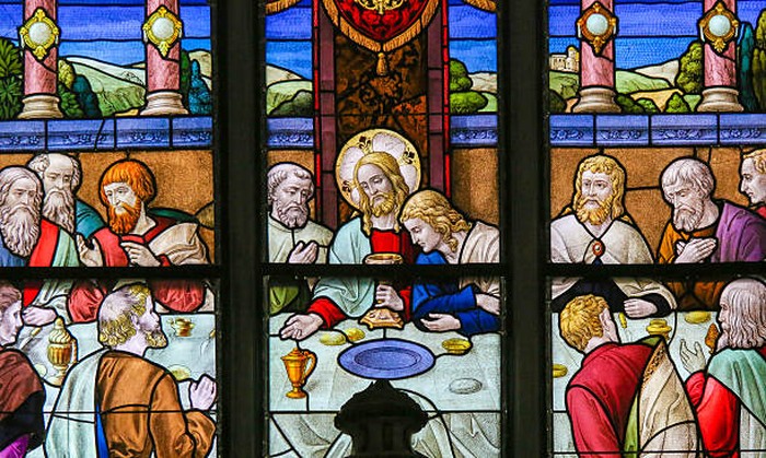 Mechelen, Belgium - November 4, 2016: Stained Glass window depicting Jesus offering communion to His Apostles at the Last Supper, in the Cathedral of Saint Rumbold in Mechelen, Belgium.