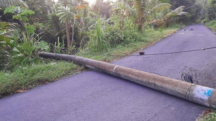 Tiang listrik milik PLN roboh dan menutup seluruh akses jalan di wilayah Banjar Dinas Babakan, Desa Gegelang, Kecamatan Manggis, Kabupaten Karangasem, Senin (25/3/2024). (istimewa)