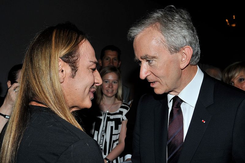 Fashion designer John Galliano and Bernard Arnault at the Christian Dior Haute Couture Fall/Winter 2008/2009 fashion show at Paris Fashion Week. (Photo by Stephane Cardinale/Corbis via Getty Images)