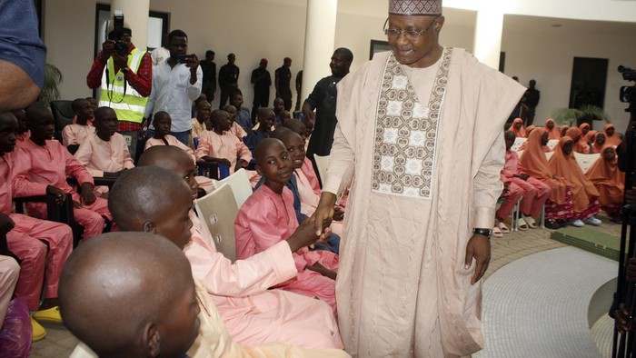 Kaduna state governor, Sani Uba, shakes hands with the freed students of the LEA Primary and Secondary School Kuriga upon their arrival at the state government house in Kaduna, Nigeria, Monday, March 25, 2024. More than 130 Nigerian schoolchildren rescued after more than two weeks in captivity have arrived in their home state in northwestern Nigeria ahead of their anticipated reunions with families. (AP Photo/Olalekan Richard)