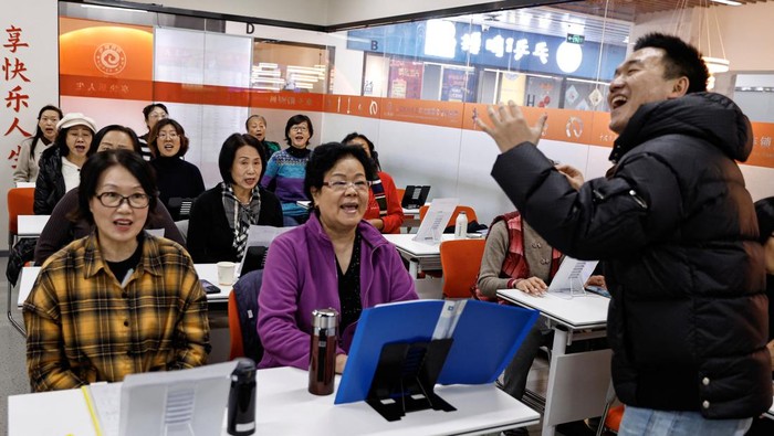 Women attend a singing class at Mama Sunset, a learning centre for middle-aged and senior people in Beijing, China January 17, 2024. REUTERS/Tingshu Wang