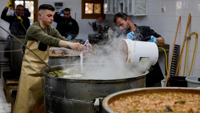 Workers cook food at Takiyya Ibrahim (Prophet Ibrahim Charity Kitchen) in the old city of Hebron in the Israeli-occupied West Bank, March 24, 2024. REUTERS/Mussa Qawasma