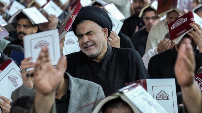 An Iraqi Shiite Muslim weeps as he prays in Laylat al-Qadr, or the Night of Destiny, during the holy fasting month of Ramadan at the shrine of Imam Moussa al-Kadhim in Baghdad, Monday, April 1, 2024. (AP Photo/Hadi Mizban)