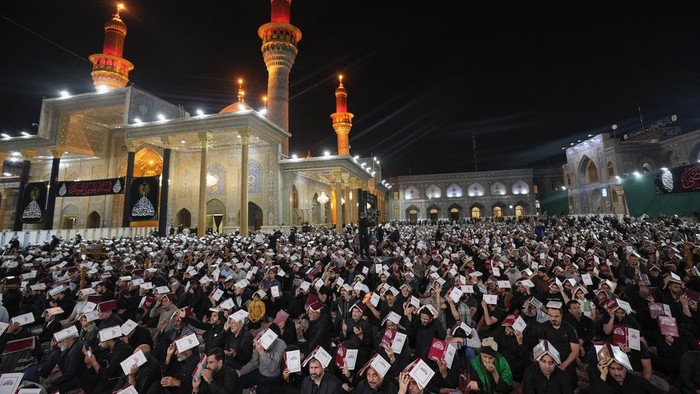 An Iraqi Shiite Muslim weeps as he prays in Laylat al-Qadr, or the Night of Destiny, during the holy fasting month of Ramadan at the shrine of Imam Moussa al-Kadhim in Baghdad, Monday, April 1, 2024. (AP Photo/Hadi Mizban)