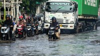 Pengendara yang melintas dari arah Bekasi menuju Jakarta harus tersendat akibat tingginya air. 