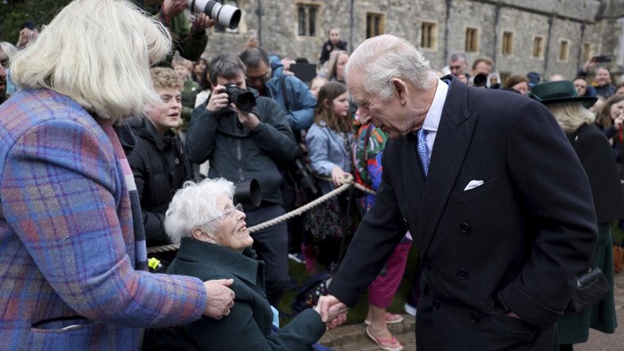 Britain's King Charles III and Queen Camilla greet people after attending the Easter Matins Service at St. George's Chapel, Windsor Castle, England, Sunday, March 31, 2024. (Hollie Adams/Pool Photo via AP)