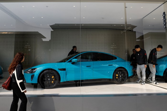 Xiaomis first electric vehicle SU7 is displayed at a showroom of a newly opened Xiaomi store in Beijing, China March 25, 2024. REUTERS/Tingshu Wang