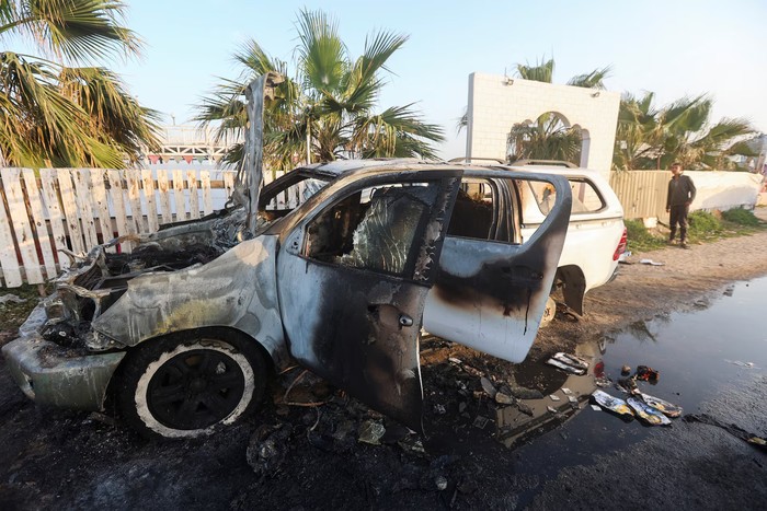 A person looks at a vehicle where employees from the World Central Kitchen (WCK) were killed in an Israeli airstrike, in Deir Al-Balah, in Gaza, April 2. REUTERS/Ahmed Zakot