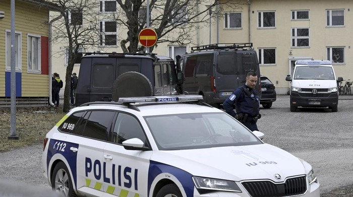 Police officers stand guard outside Viertola comprehensive school, in Vantaa, Finland, Tuesday, April 2, 2024. Police in Finland say a 12-year-old student has opened fire at a secondary school in southern Finland and wounded three other students. The suspect was later arrested. Heavily armed police on Tuesday cordoned off the lower secondary school, with some 800 students, in the city of Vantaa, just outside the capital, Helsinki, after receiving a call about a shooting incident at 09:08 a.m. Police said both the suspect and the wounded were 12 years old.  (Markku Ulander/Lehtikuva via AP)