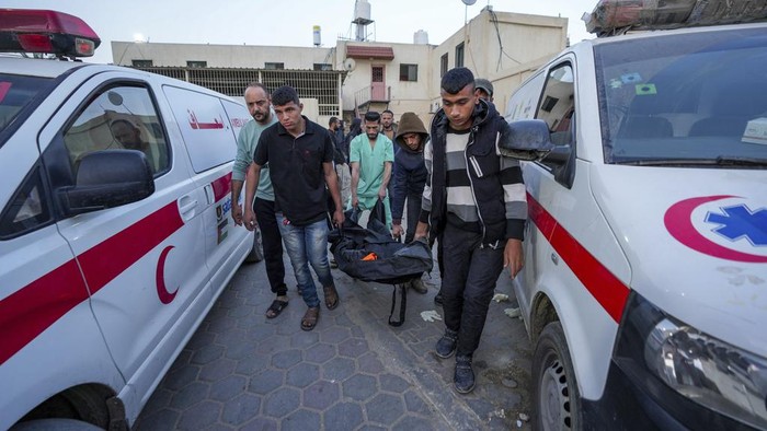 People inspect the site where World Central Kitchen workers were killed in Deir al-Balah, Gaza Strip, Tuesday, April 2, 2024. World Central Kitchen, an aid group, says an Israeli strike that hit its workers in Gaza killed at least seven people, including several foreigners. (AP Photo/Abdel Kareem Hana)