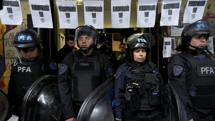 State employees enter their workplace after they were temporarily prevented from entering their workplace due to an
anti-government protest in support of workers who were laid off as part of state economic downsizing measures, in Buenos Aires, Argentina, Wednesday, April 3, 2024. According to the State Workers Association, more than 11 thousand dismissals of state employees have been carried out by Javier Milei’s government. (AP Photo/Gustavo Garello)