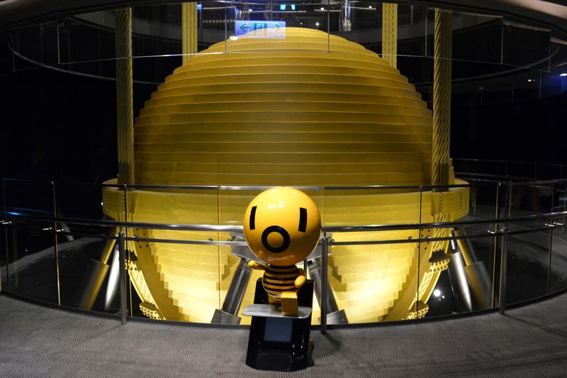 Taipei, Taiwan - September 23, 2016: Tuned mass damper inside the Taipei 101 skyscraper. Also known as a harmonic absorber, is a device mounted in structures to reduce the amplitude of mechanical vibrations. It can prevent damage, or outright structural failure.