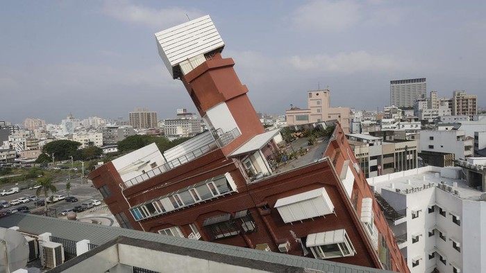 A partially collapsed building stands at a titled angle a day after a powerful earthquake struck in Hualien City, eastern Taiwan, Thursday, April 4, 2024. (AP Photo/Chiang Ying-ying)