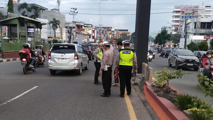 Polisi saat mengevakuasi korban kecelakaan di Palembang