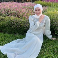 Selebgram hijab Astri Ratnasari mengunggah foto OOTD dengan memakai dress shimmer warna sage. Astri menambahkan bros motif pita dan mengenakan hijab pashmina warna putih.  Foto: Dok. Instagram @nasariastri.