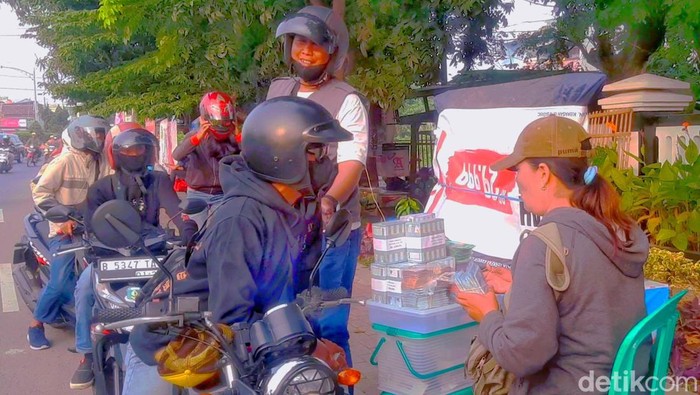 Juni saat bertaransaksi menukar uang baru dengan pemudik di Jalur Arteri Jalan Nasional Pantura Lingkar Tanjungpura Kabupaten Karawang