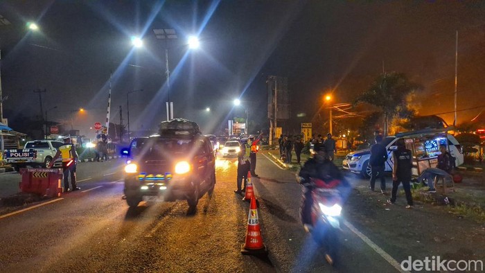 Polisi melakukan pengaturan pemisahan kendaraan atau kanalisasi di Jalan Nagreg, Kabupaten Bandung, Minggu (7/4/2024) malam