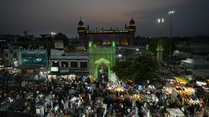 Muslims shop ahead of Eid al-Fitr in front of the Charminar monument in Hyderabad, India, Tuesday, April 9, 2024. Eid al-Fitr marks the end of the holy fasting month of Ramadan. (AP Photo/Mahesh Kumar A.)