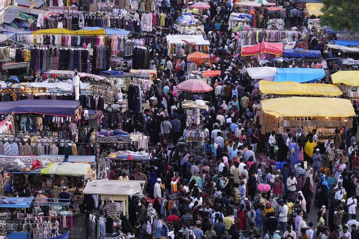 Muslims shop ahead of Eid al-Fitr in front of the Charminar monument in Hyderabad, India, Tuesday, April 9, 2024. Eid al-Fitr marks the end of the holy fasting month of Ramadan. (AP Photo/Mahesh Kumar A.)