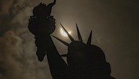 The moon partially covers the sun behind the Statue of Liberty during the a solar eclipse on the Liberty Island, Monday, April 8, 2024, in New York. (AP Photo/Yuki Iwamura)