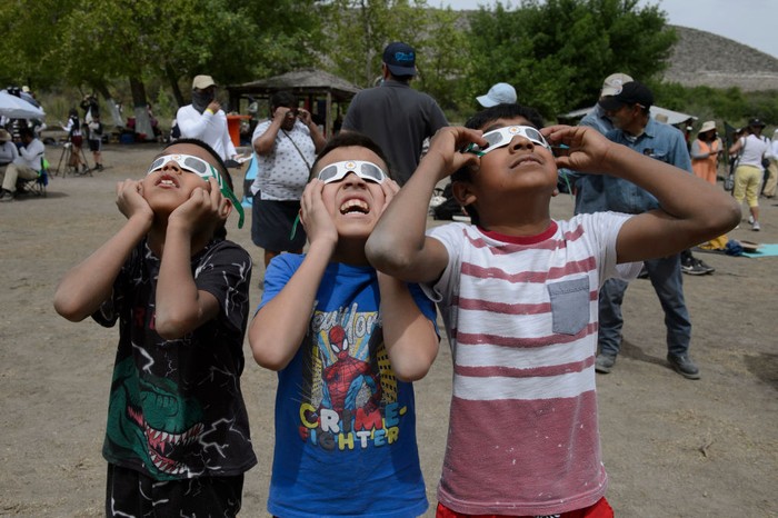 OCAMPO, MEXICO - APRIL 08: Children observe the sky as it gets darker at Parque la Mota on April 08, 2024 in Ocampo, Mexico. Millions of people have flocked to areas across North America that are in the 