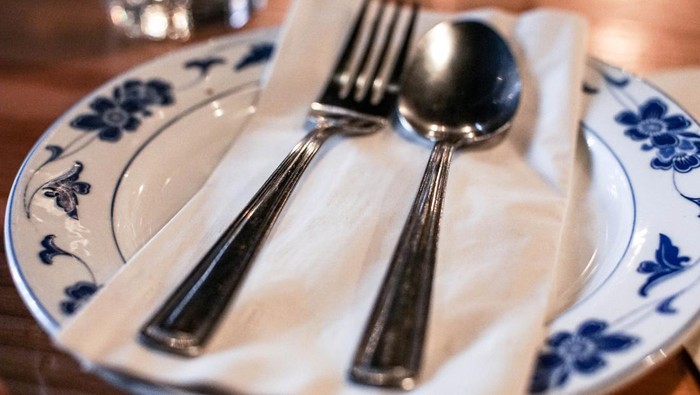 porcelain plate with silver spoon and fork