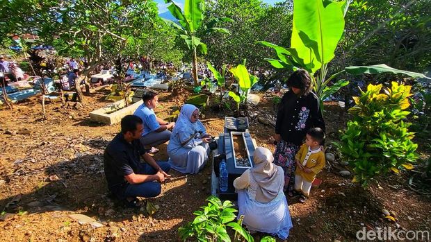 Warga berziarah ke makam di Pemakaman Umum Batu Sapi.