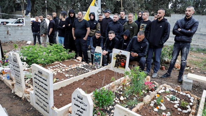 Palestinians visit the graves of their relatives who were killed by Israel, on the first day of Eid al-Fitr, which marks the end of the Muslim holy fasting month of Ramadan, in Jenin camp in the Israeli-occupied West Bank, April 10, 2024. REUTERS/Raneen Sawafta