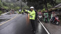 Polisi mengatur arus lalu lintas saat diberlakukan sistem one way atau satu arah di Jalur Selatan, Kadipaten, Kabupaten Tasikmalaya, Jawa Barat, Jumat (12/4/2024).