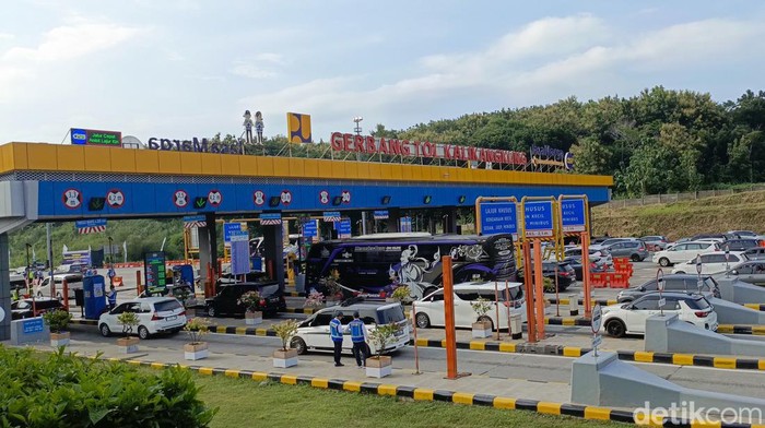 Menhub Budi Karya Sumadi memberikan bunga ke pemudik arus balik di Tol Kalikangkung, Sabtu (13/4/2024).