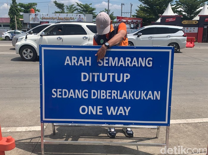Petugas memasang rambu peringatan pemberlakuan one way, Sabtu (13/4/2024)
