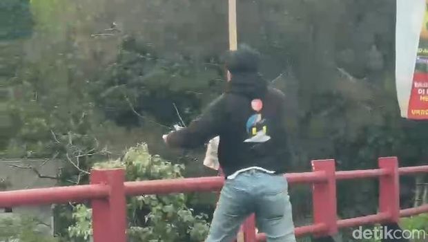 Tangkapan layar video pria buang sampah ke sungai di Jalur Puncak, Cianjur.