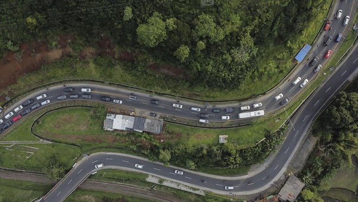 Foto udara kendaraan pemudik memadati di Jalur Selatan, Lingkar Gentong, Kabupaten Tasikmalaya, Jawa Barat, Sabtu (13/4/2024). Dishub Kabupaten Tasikmalaya mencatat traffic counting atau Cacahan lalu lintas volume kendaraan yang melintas dari arah Tasikmalaya menuju Bandung dan Jakarta pada hari lebaran hingga H+3 arus balik lebaran sebanyak 165.997 pemudik dan terjadi kepadatan. ANTARA FOTO/Adeng Bustomi/nz