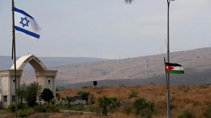 The national flags of Jordan and Israel are seen from the Israeli side of the border area between Israel and Jordan, in Naharayim, on October 29, 2019. (Reuters)