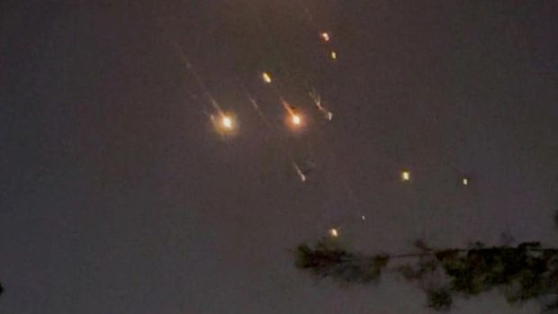 Objects are seen in the sky over Amman after Iran launched drones towards Israel, in Amman, Jordan April 14, 2024, in this screen grab obtained from a social media video. Video Obtained by REUTERS/via REUTERS  THIS IMAGE HAS BEEN SUPPLIED BY A THIRD PARTY.