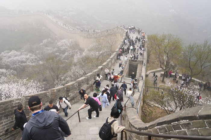 Visitors walk on a stretch of the Badaling Great Wall in Beijing, Saturday, April 13, 2024. (AP Photo/Tatan Syuflana)