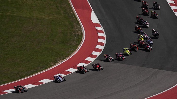 MotoGP rider Maverick Vinales, left, of Spain, leads through a turn in the sprint race during the MotoGP Grand Prix of the Americas motorcycle race at the Circuit of the Americas, Saturday, April 13, 2023, in Austin, Texas. (AP Photo/Eric Gay)