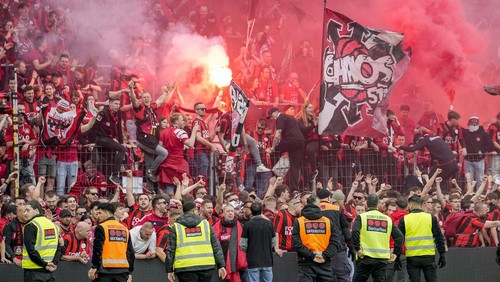 Leverkusen fans celebrate after Bayer Leverkusen won the German Bundesliga title beating Werder Bremen in Leverkusen, Germany, Sunday, April 14, 2024. (AP Photo/Martin Meissner)