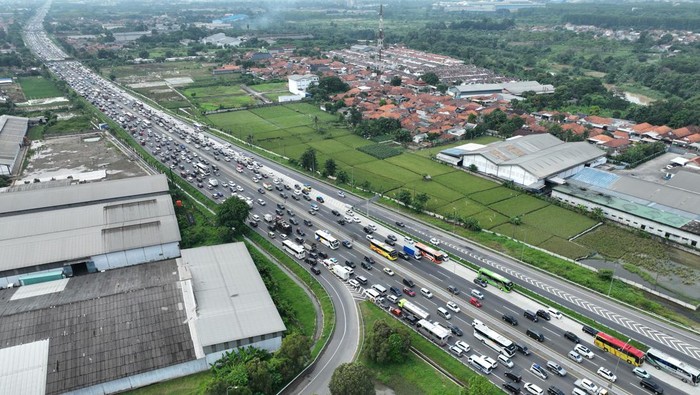 Foto udara sejumlah kendaraan arus balik arah Jakarta terjebak kemacetan di Tol Jakarta-Cikampek (Japek), Karawang Timur, Jawa Barat, Senin (15/4/2024). Korlantas Polri memberlakukan contraflow dua lajur pada KM 72 Tol Cipali hingga KM 66 Tol Japek, tiga lajur pada KM 66-47 Tol Japek dan satu lajur pada 47-36 Tol Japek guna memperlancar arus balik Lebaran 2024. ANTARA FOTO/Akbar Nugroho Gumay/Spt.
