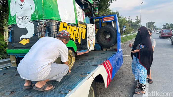 Pemudik asal Jakarta yang bajajnya jebol di Mojokerto akhirnya diantar pulang naik truk towing milik polisi.